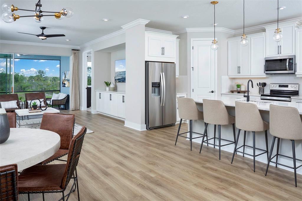 17787 Stillness Court Venice, FL 34293 - Photo 12 of 36 a view of a dining room with furniture window and wooden floor