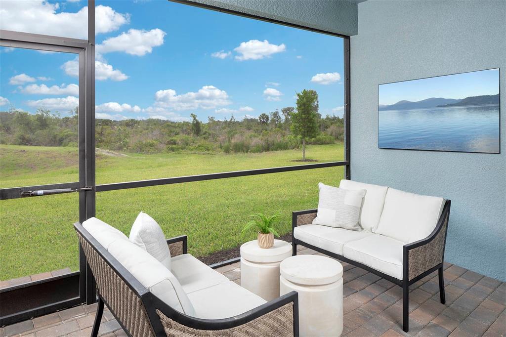 17787 Stillness Court Venice, FL 34293 - Photo 13 of 36 a living room with furniture and a floor to ceiling window