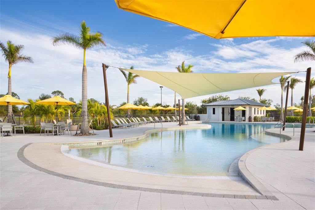 17787 Stillness Court Venice, FL 34293 - Photo 28 of 36 a view of a swimming pool with a lawn chairs under an umbrella