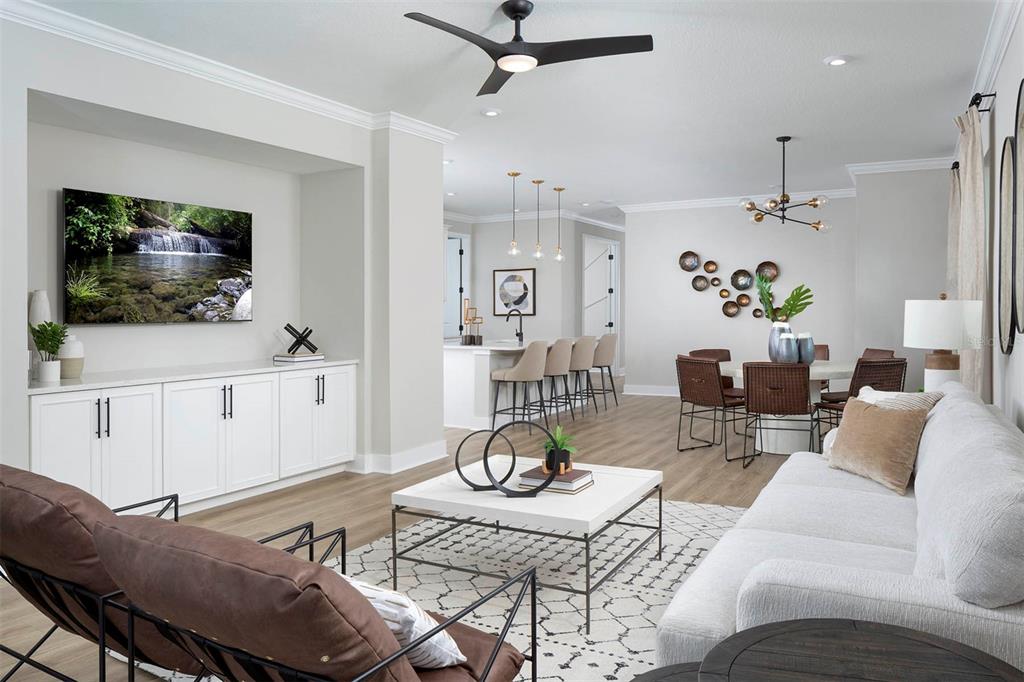 17787 Stillness Court Venice, FL 34293 - Photo 7 of 36 a living room with furniture a flat screen tv and kitchen view
