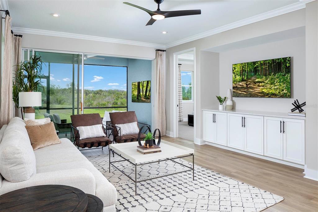 17787 Stillness Court Venice, FL 34293 - Photo 9 of 36 a living room with furniture tv and a large window