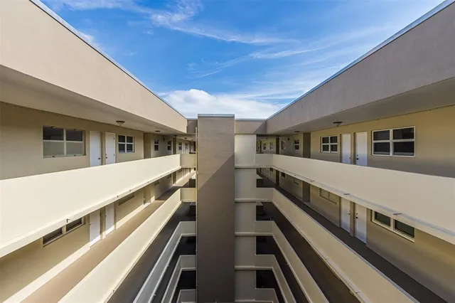 a view of an outdoor space with wooden floor and windows