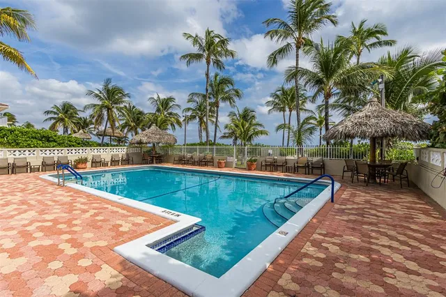 a front view of a garden with palm trees