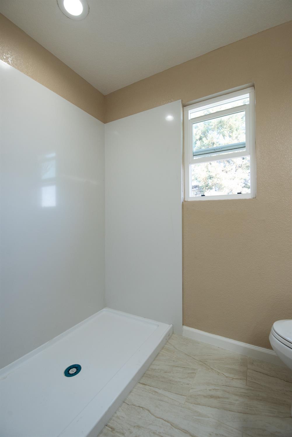 1621 Davis Street Ripon, CA 95366 - Photo 37 of 43 full bath with a stall shower and baseboards