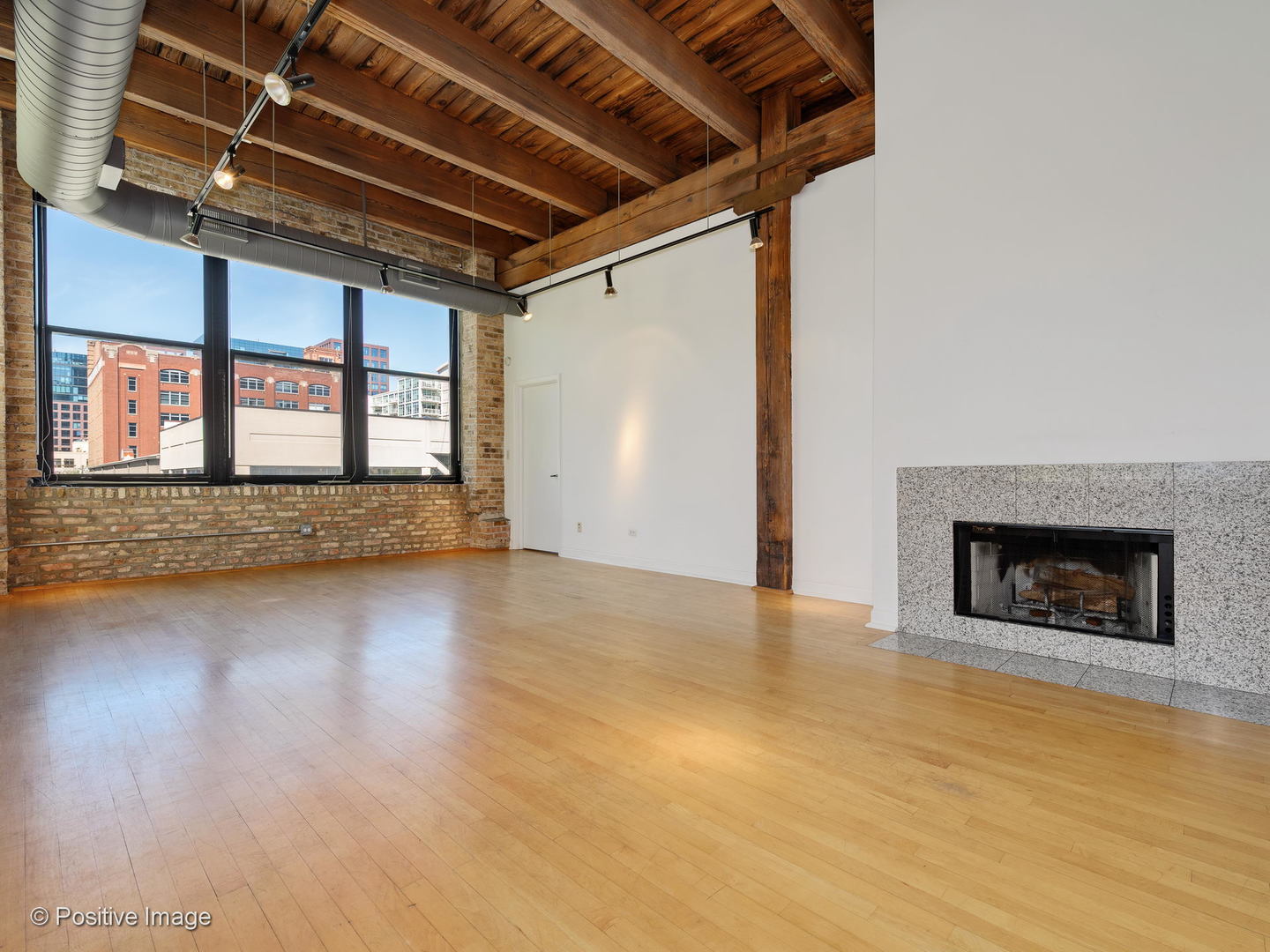 11 North Green Street, Unit 3CD Chicago, IL 60607 - Photo 2 of 40 an empty room with wooden floor and a fireplace