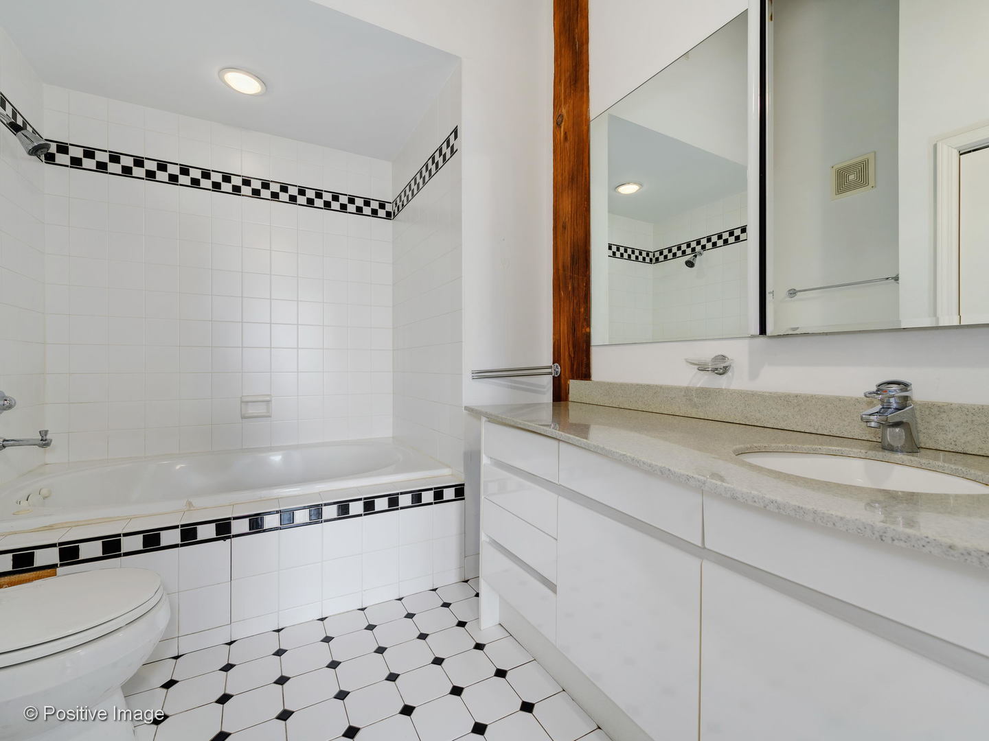 11 North Green Street, Unit 3CD Chicago, IL 60607 - Photo 19 of 40 a bathroom with a granite countertop sink a mirror and a bathtub