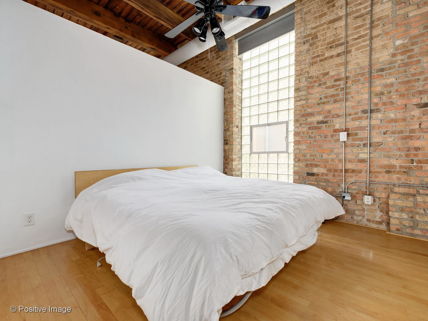 11 North Green Street, Unit 3CD Chicago, IL 60607 - Photo 34 of 40 a large bed sitting in a bedroom next to a window