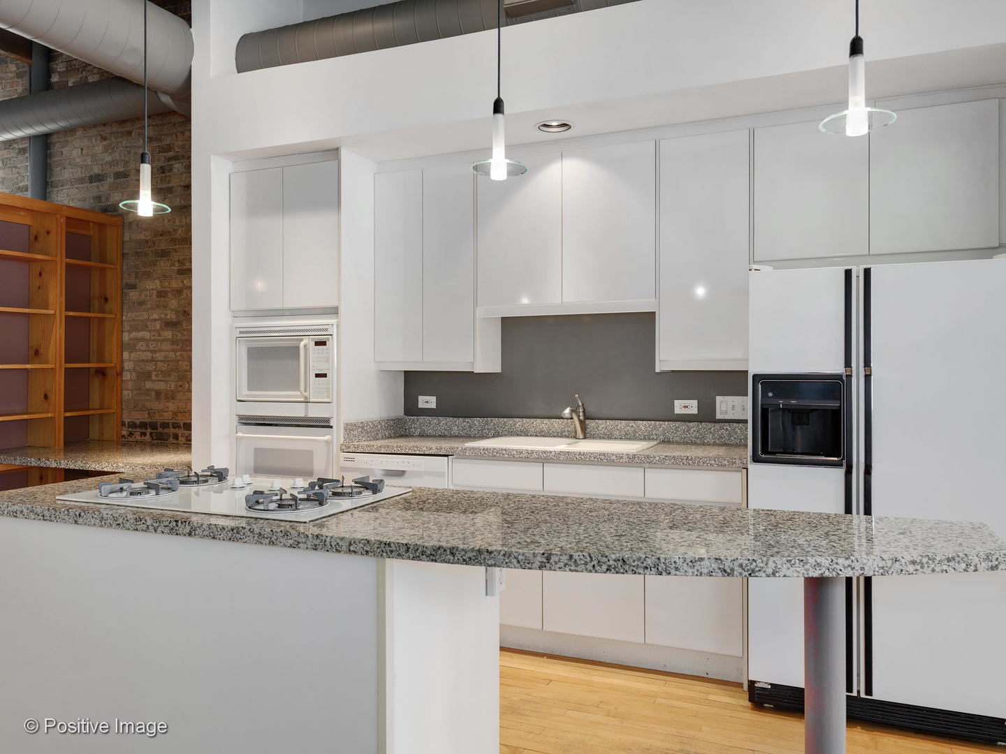 11 North Green Street, Unit 3CD Chicago, IL 60607 - Photo 7 of 40 a kitchen with kitchen island granite countertop a sink a counter top space cabinets and stainless steel appliances
