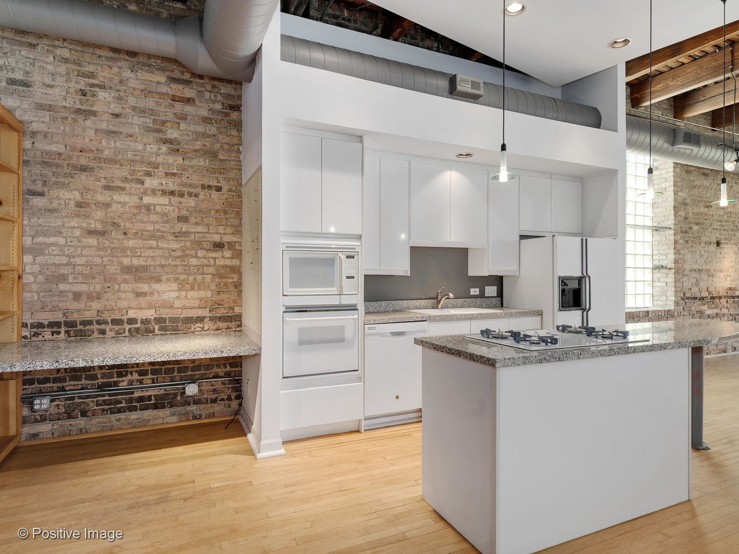 11 North Green Street, Unit 3CD Chicago, IL 60607 - Photo 9 of 40 a kitchen with kitchen island a stove a sink and a refrigerator
