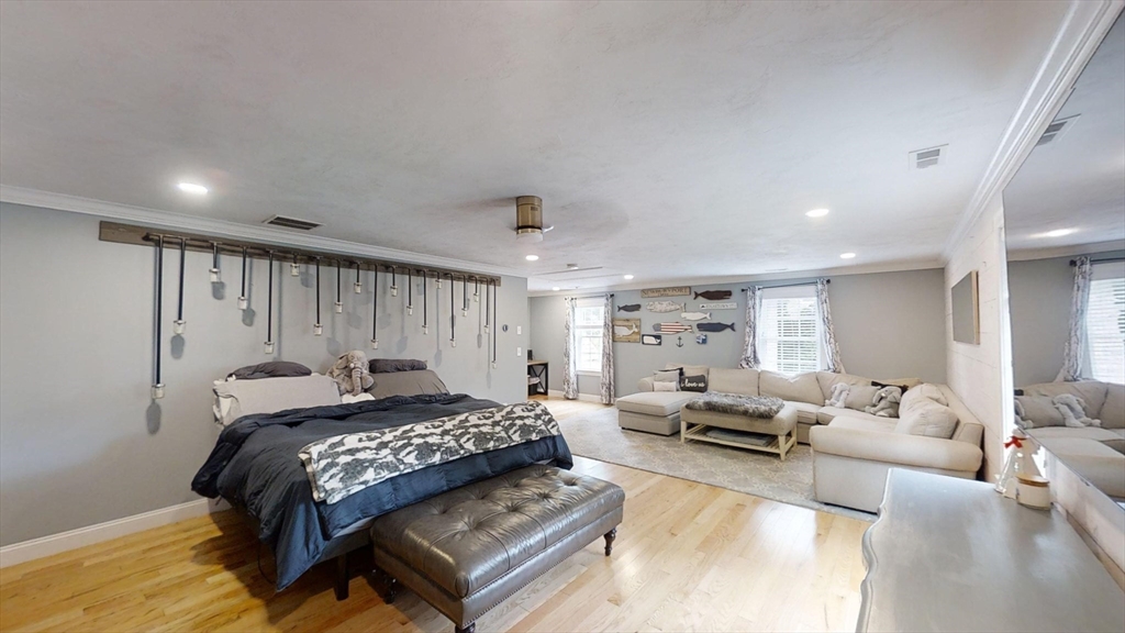223 Old Common Road Lancaster, MA 01523 - Photo 14 of 31 a spacious bedroom with a bed a couch and a window