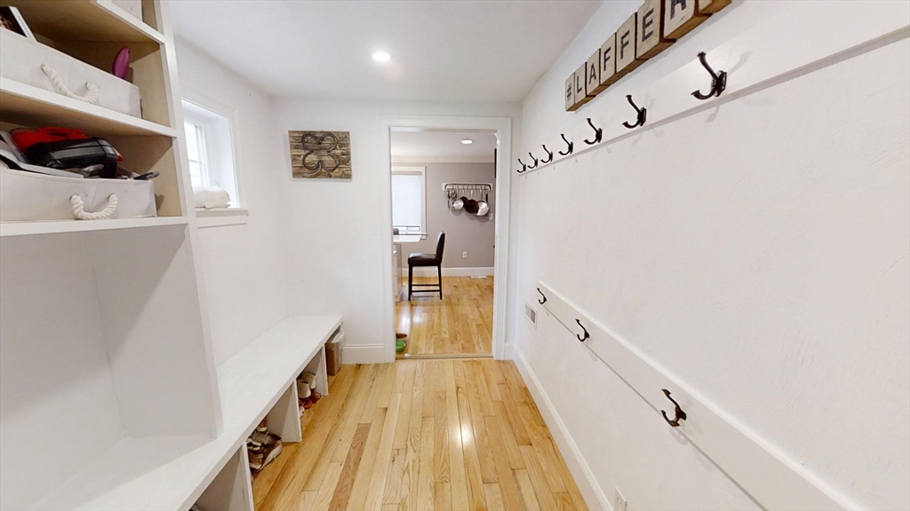 223 Old Common Road Lancaster, MA 01523 - Photo 7 of 31 a view of a hallway with wooden floor and staircase