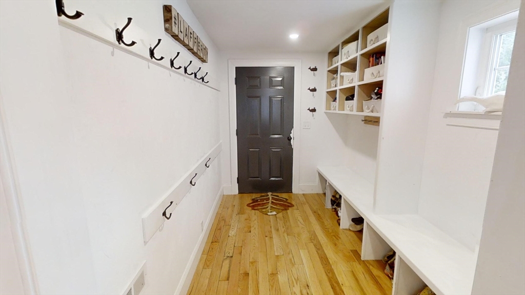 223 Old Common Road Lancaster, MA 01523 - Photo 8 of 31 a view of a hallway with wooden floor and staircase