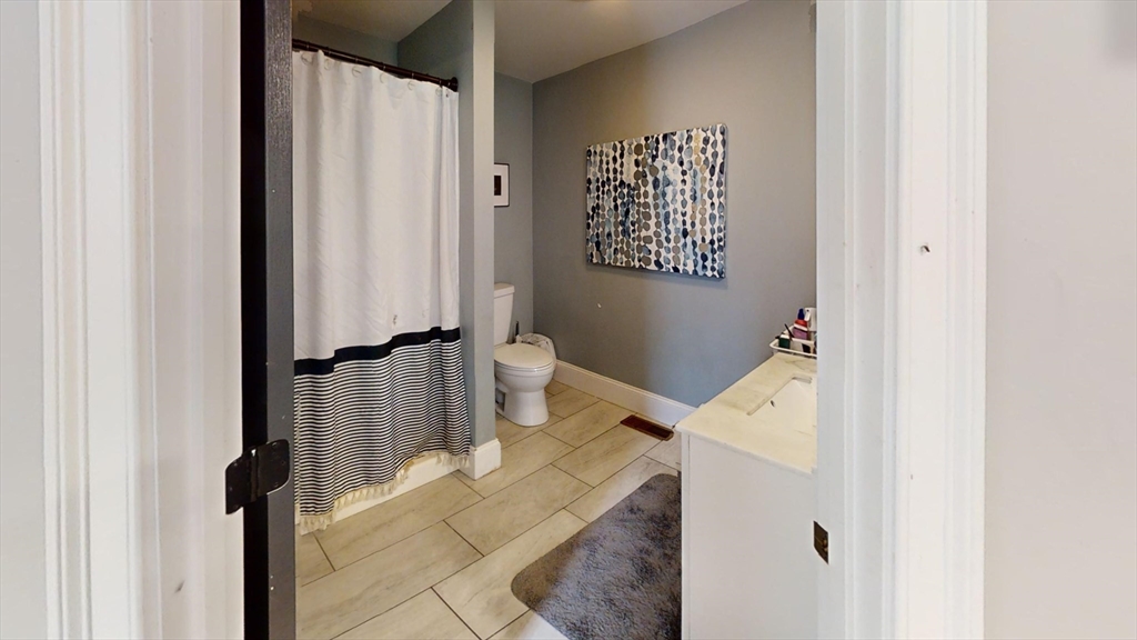 223 Old Common Road Lancaster, MA 01523 - Photo 10 of 31 a bath room with a sink and a mirror