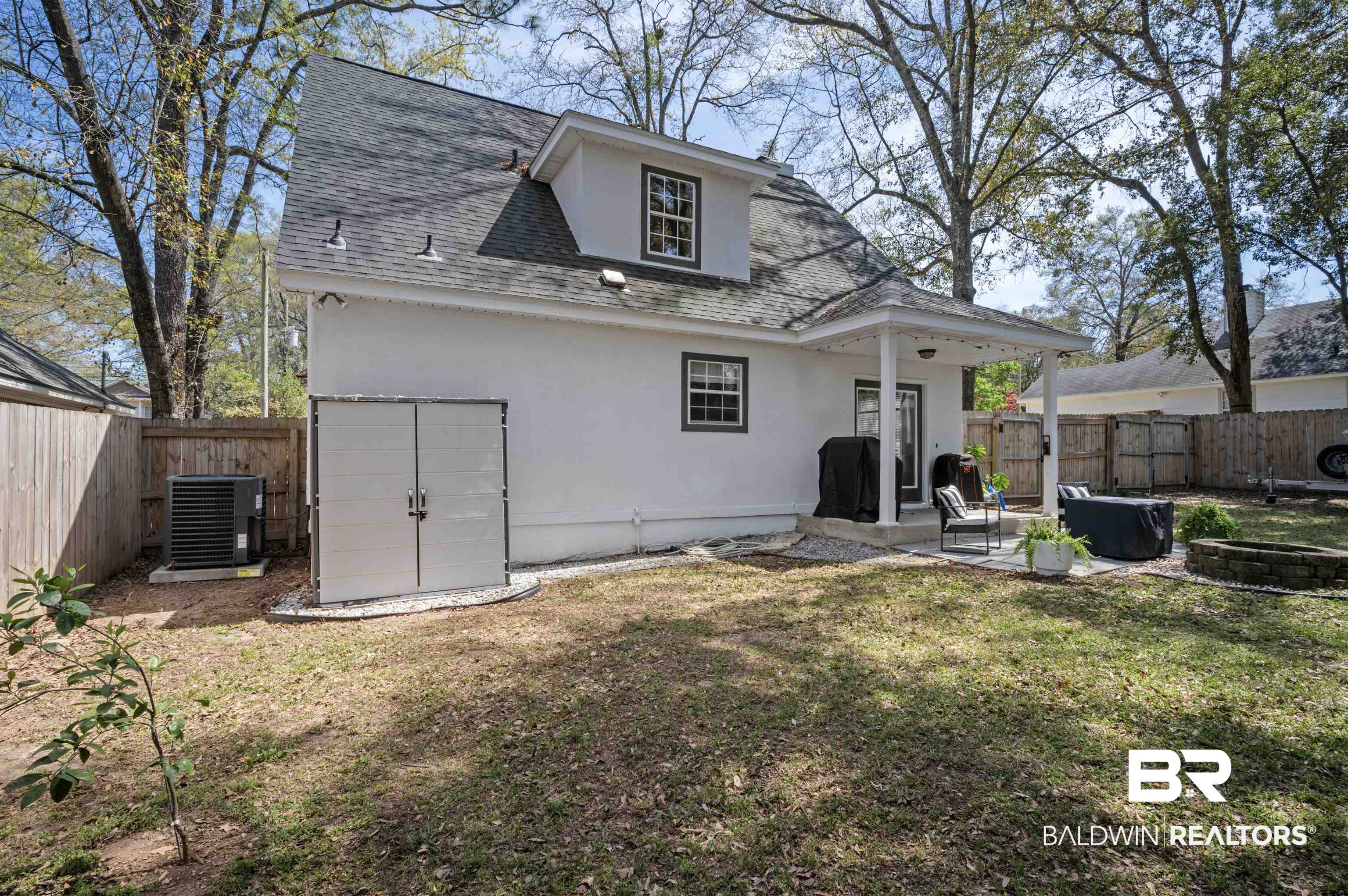 1066 Linlen Avenue Mobile, AL 36609 - Photo 22 of 22 Back of property with a fenced backyard, stucco siding, a patio area, and roof with shingles