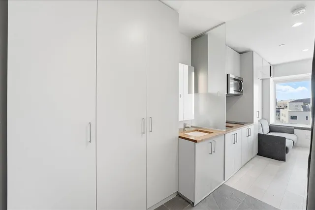 a kitchen with stainless steel appliances granite countertop a refrigerator and a stove top oven