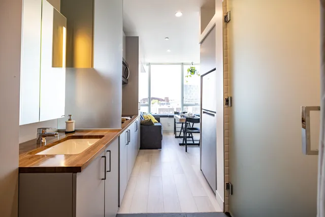 a kitchen with sink cabinets and wooden floor