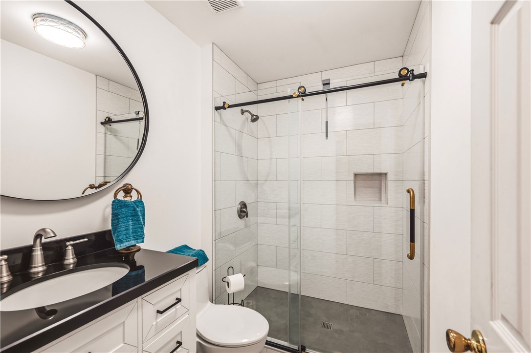 2001 Ridgeview Lane Seneca, SC 29678 - Photo 15 of 27 Modern fixtures enhance this freshly designed bathroom, featuring a sleek vanity and an elegant walk-in shower.