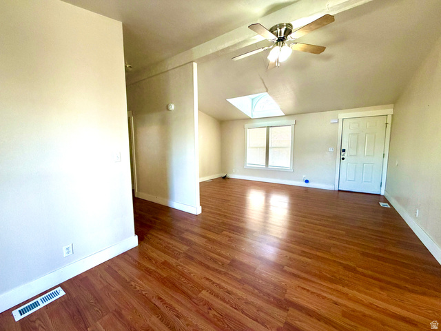 1025 North 300 West, Unit 1 Springville, UT 84663 - Photo 4 of 35 Empty room featuring lofted ceiling, a skylight, dark wood-style flooring, and a ceiling fan
