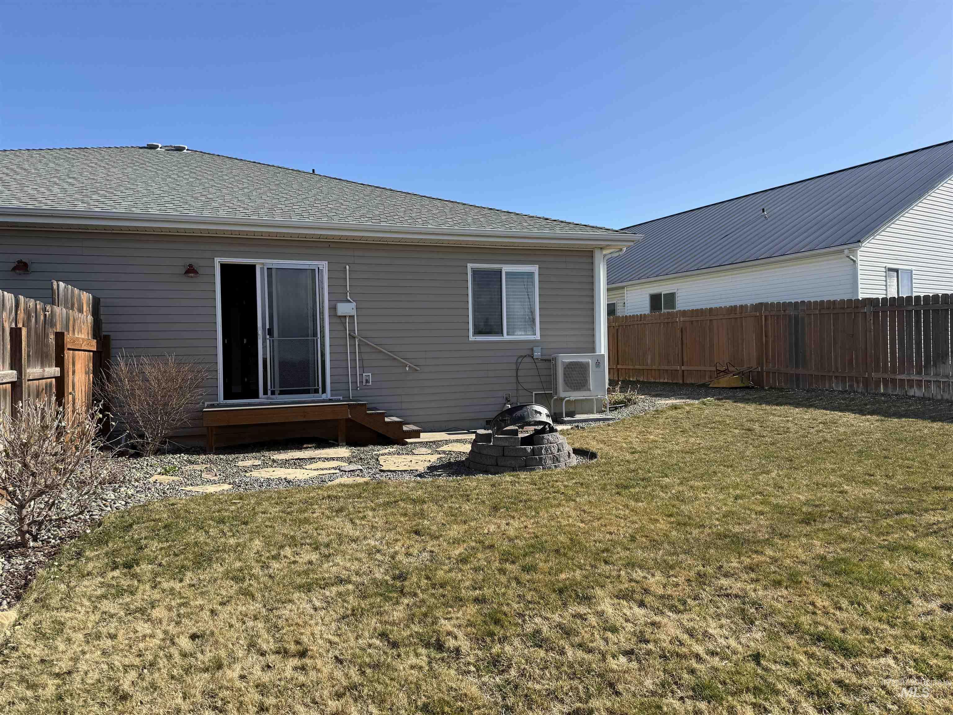 257 Pintail Lane Moscow, ID 83843 - Photo 28 of 28 Back of property with a fenced backyard, a shingled roof, and a fire pit