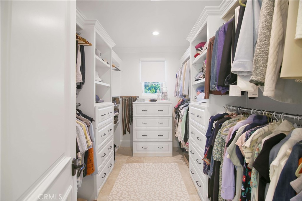 1015 Gardena Road Encinitas, CA 92024 - Photo 20 of 42 a view of walk in closet with clothes and shoes