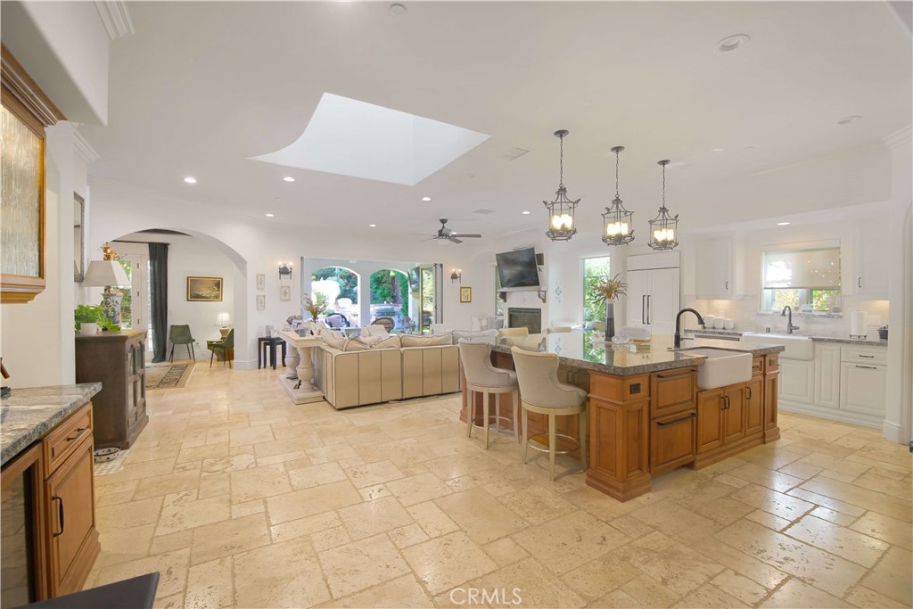 1015 Gardena Road Encinitas, CA 92024 - Photo 2 of 42 a large white kitchen with lots of white furniture and chandelier