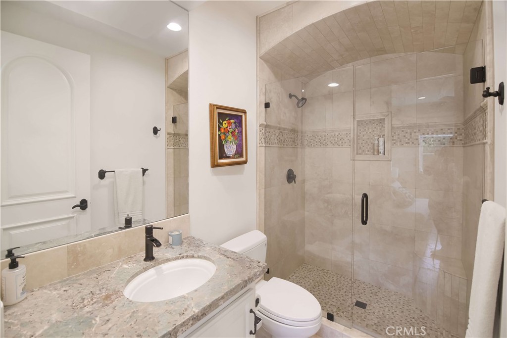 1015 Gardena Road Encinitas, CA 92024 - Photo 28 of 42 a bathroom with a shower sink vanity mirror and toilet