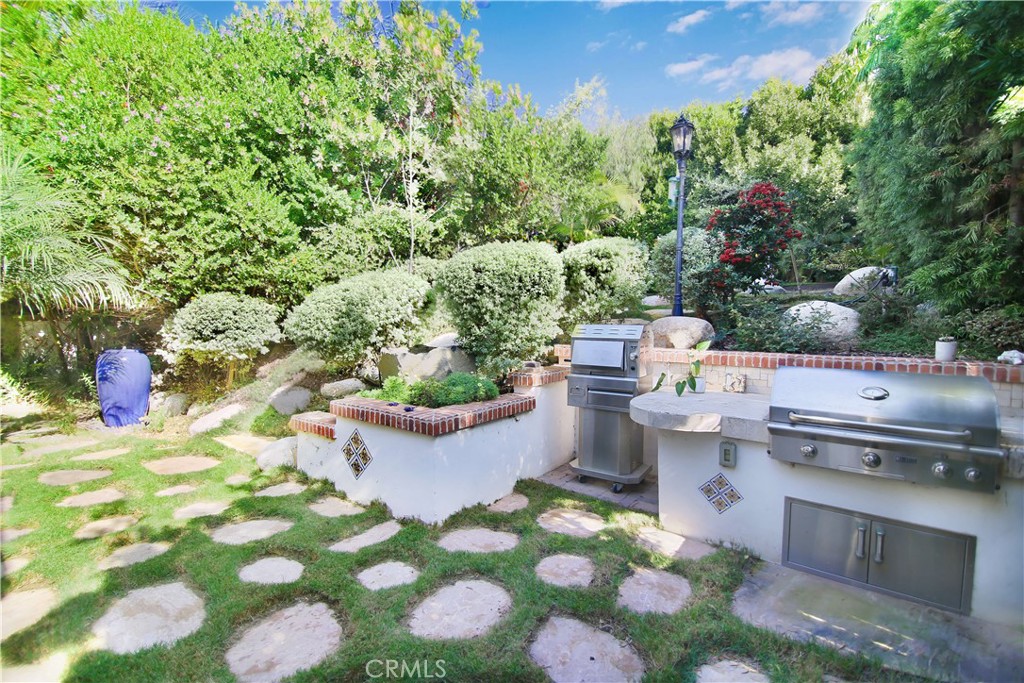 1015 Gardena Road Encinitas, CA 92024 - Photo 35 of 42 a view of a backyard with garden and flowers