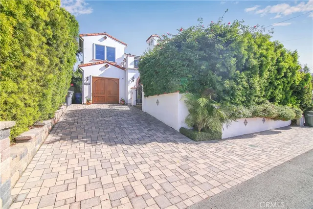 an aerial view of multiple houses with a yard