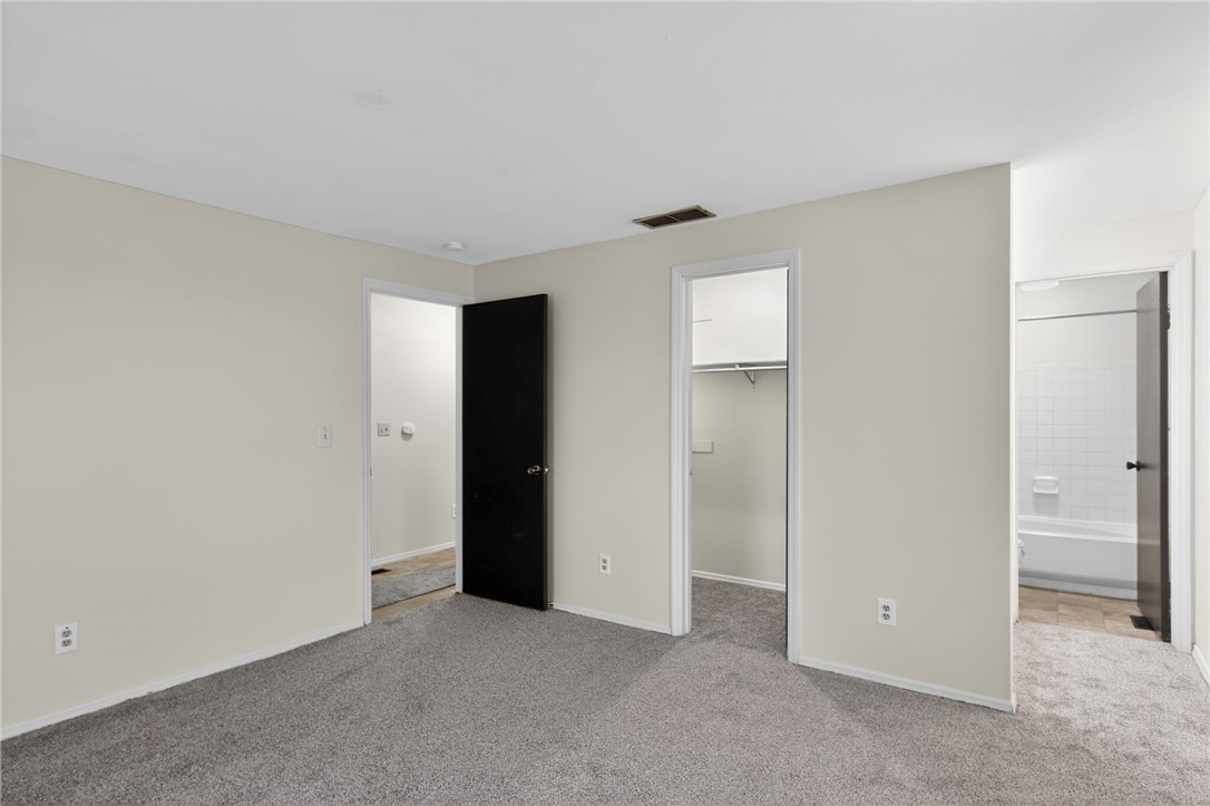 6070 Charlesgate Road Huber Heights, OH 45424 - Photo 20 of 29 This spacious bedroom offers comfortable carpeting and convenient access to a closet and a full bathroom.