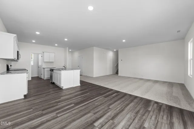 a view of kitchen with wooden floor and electronic appliances