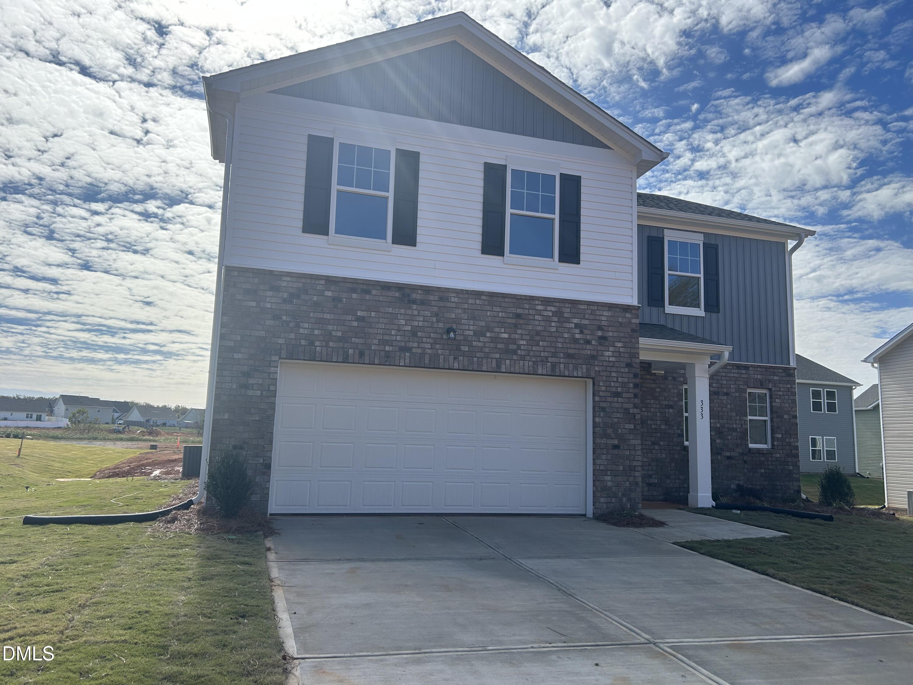 333 Shiloh Way Mebane, NC 27302 - Photo 2 of 35 a front view of a house with a yard and lake view