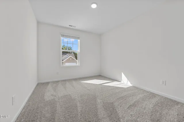 a view of an empty room and a window