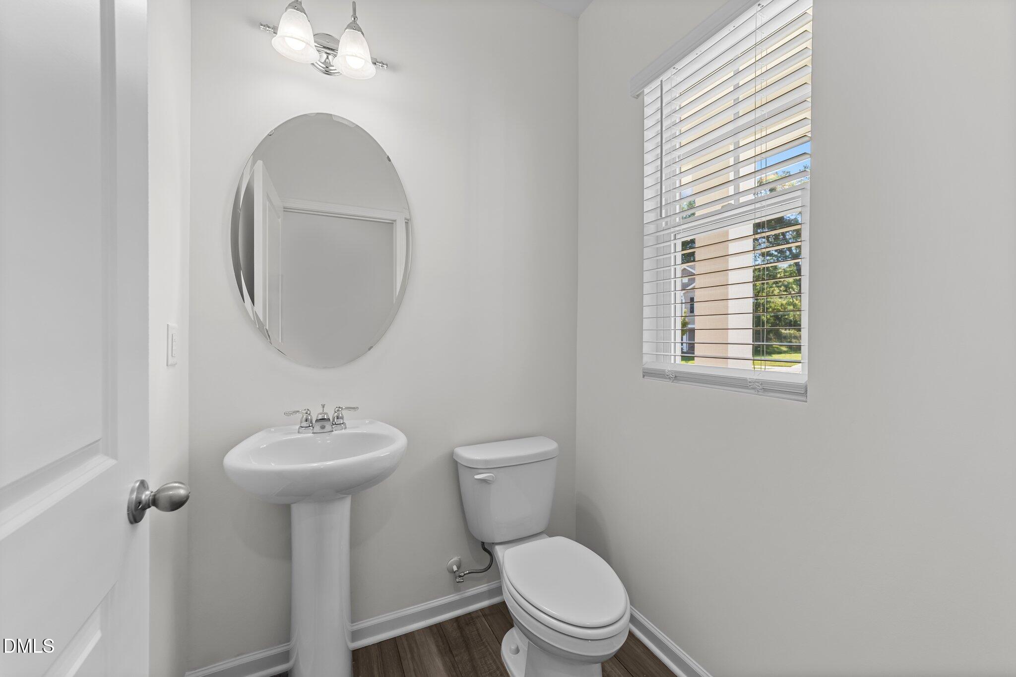 333 Shiloh Way Mebane, NC 27302 - Photo 5 of 35 a bathroom with a toilet a sink and a mirror