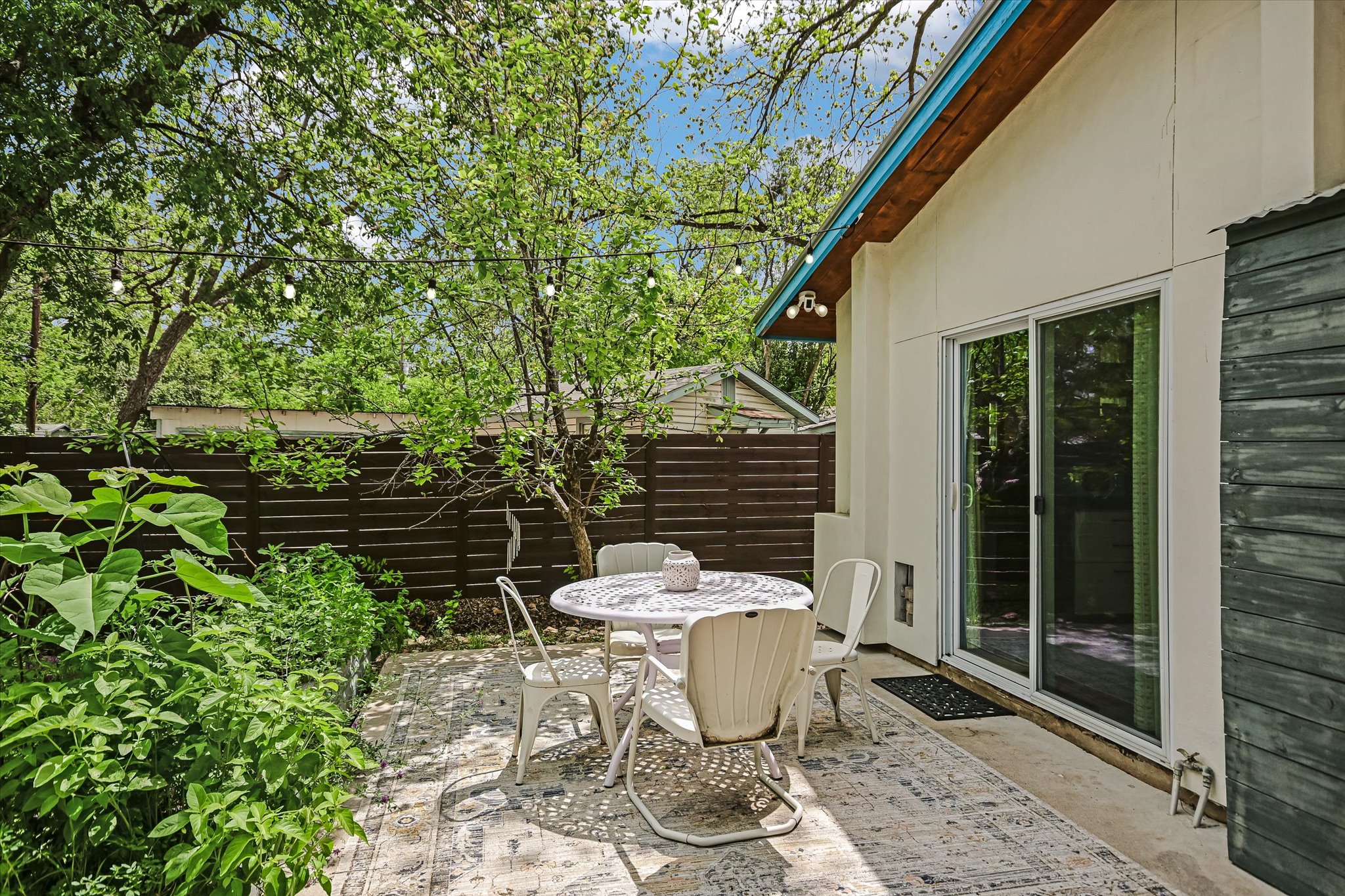 504 Powell Circle Austin, TX 78704 - Photo 18 of 23 a view of a backyard with table and chairs and potted plants