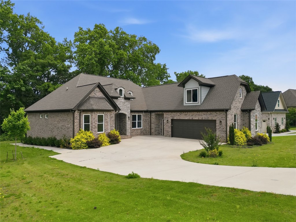 105 Bree Drive Anderson, SC 29621 - Photo 14 of 48 A graceful brick and stone facade welcomes with an inviting driveway leading to a spacious garage.