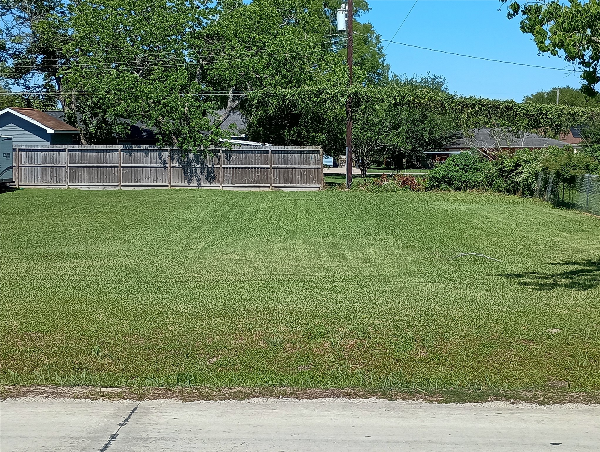 0 Fairwood Road Hitchcock, TX 77563 - Photo 2 of 7 The front of the lot facing to the back showing a nice level ground and heathy green grass.