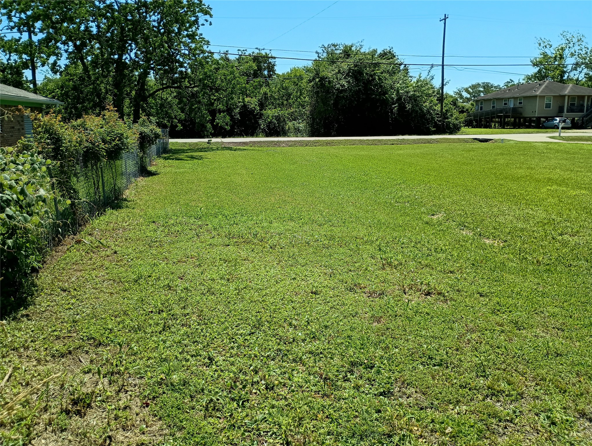 0 Fairwood Road Hitchcock, TX 77563 - Photo 3 of 7 The left side back corner of the lot facing Fairwood Road.