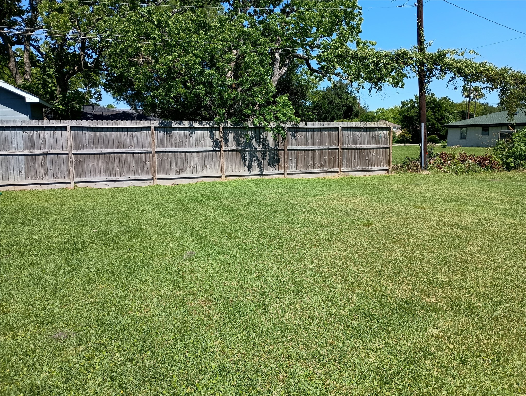 0 Fairwood Road Hitchcock, TX 77563 - Photo 7 of 7 The front of the lot facing the backyard. A neighbor's wooden fence covers most of the back of the property.