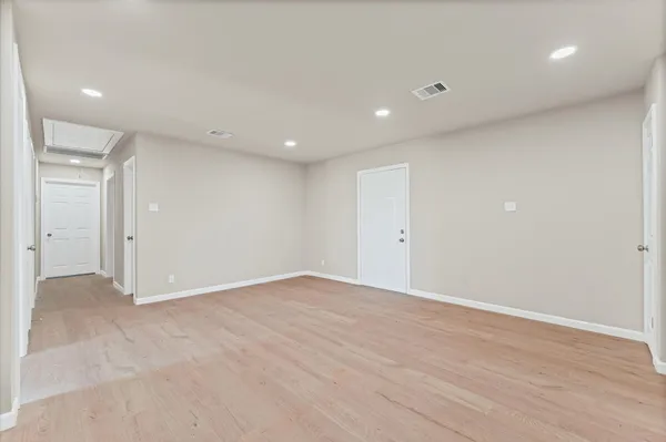 a view of a kitchen with white cabinets
