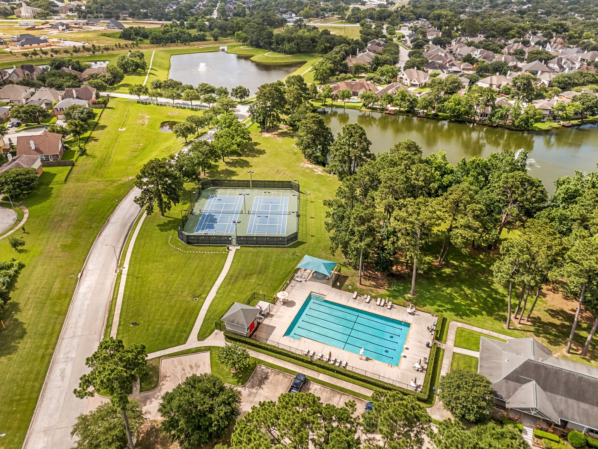 6006 Valhalla Drive Spring, TX 77379 - Photo 44 of 44 Residents enjoy access to a community pool, open green spaces, and picturesque lake views.