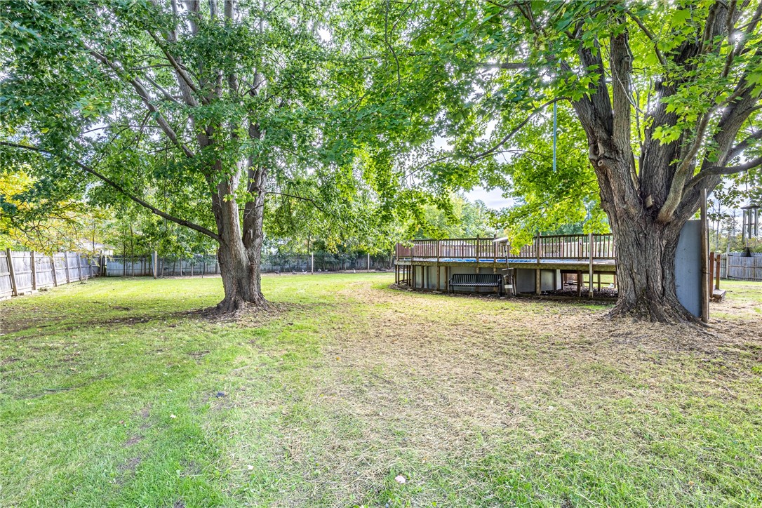6432 Lakeside Road Ontario, NY 14519 - Photo 35 of 35 Mature trees shade a spacious lawn featuring an above ground pool with surrounding deck.