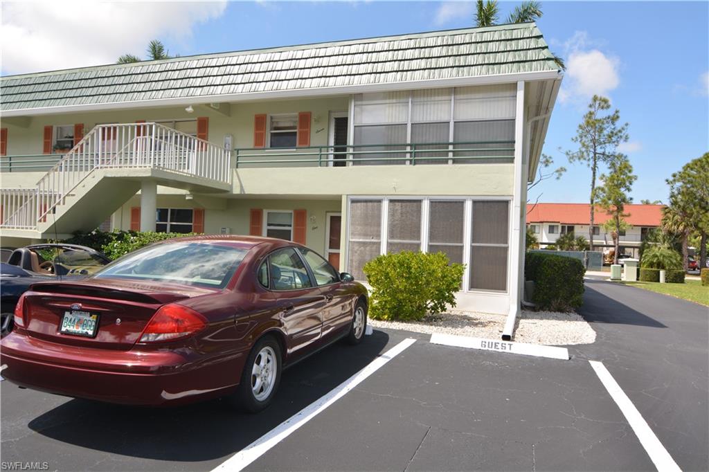 300 Valley Stream Drive, Unit A7 Naples, FL 34113 - Photo 1 of 23 a car parked in front of a building
