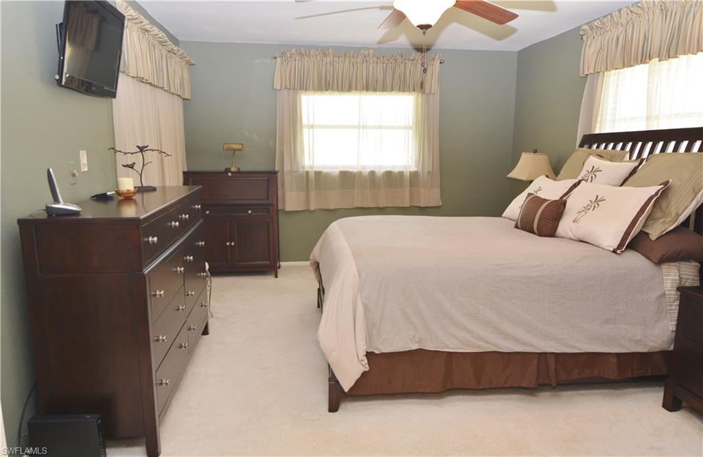 300 Valley Stream Drive, Unit A7 Naples, FL 34113 - Photo 11 of 23 a spacious bedroom with a bed and a window