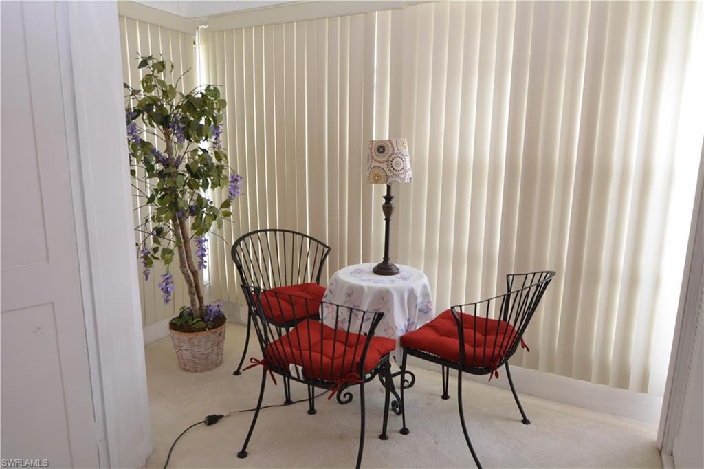 300 Valley Stream Drive, Unit A7 Naples, FL 34113 - Photo 16 of 23 a view of a dining room with furniture and a window