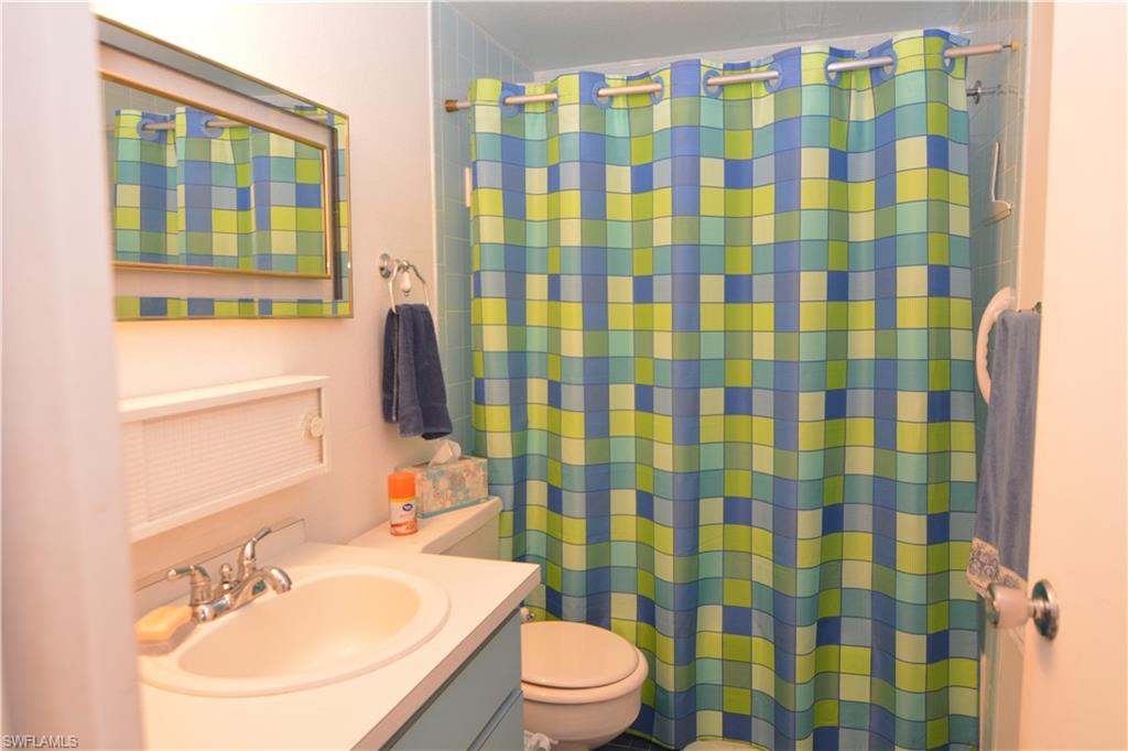 300 Valley Stream Drive, Unit A7 Naples, FL 34113 - Photo 18 of 23 a bathroom with a sink toilet and shower