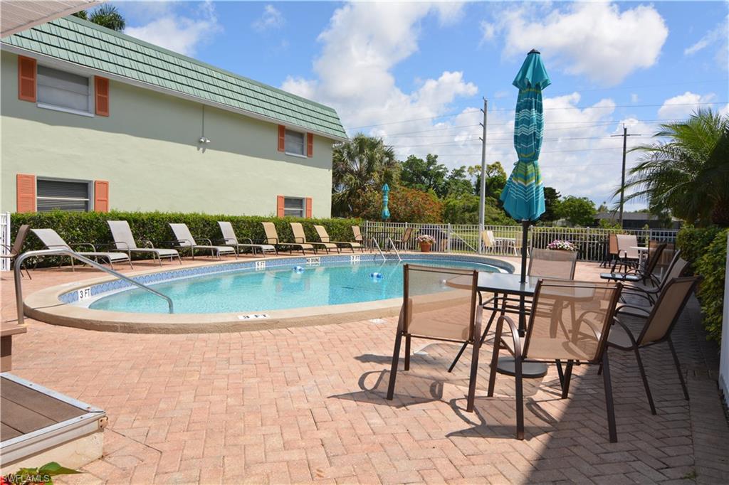 300 Valley Stream Drive, Unit A7 Naples, FL 34113 - Photo 20 of 23 a view of a swimming pool with outdoor seating