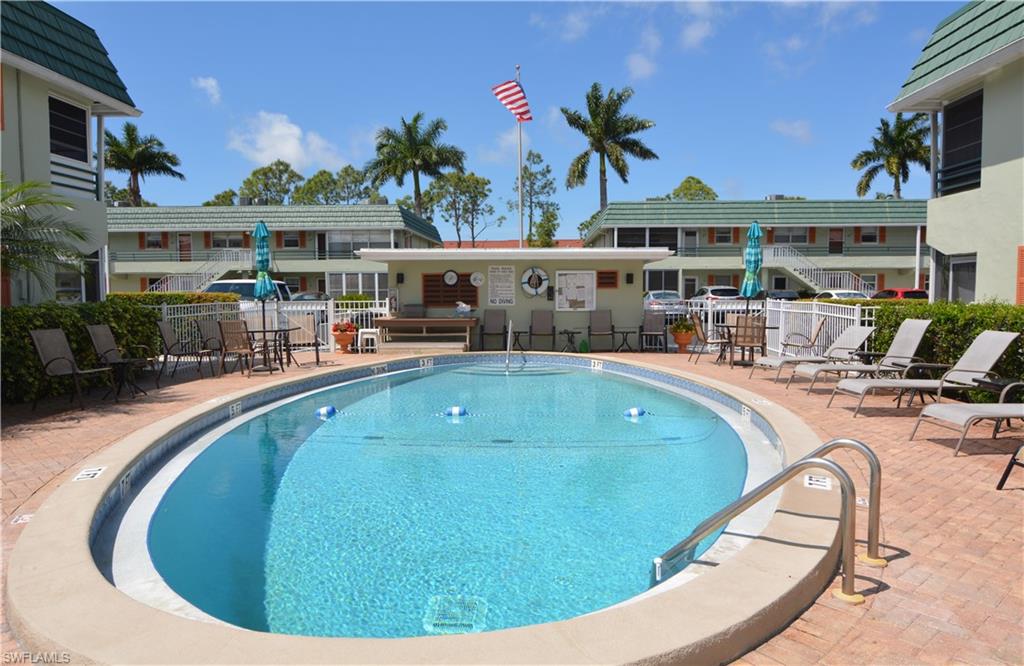 300 Valley Stream Drive, Unit A7 Naples, FL 34113 - Photo 22 of 23 a view of a swimming pool with a patio