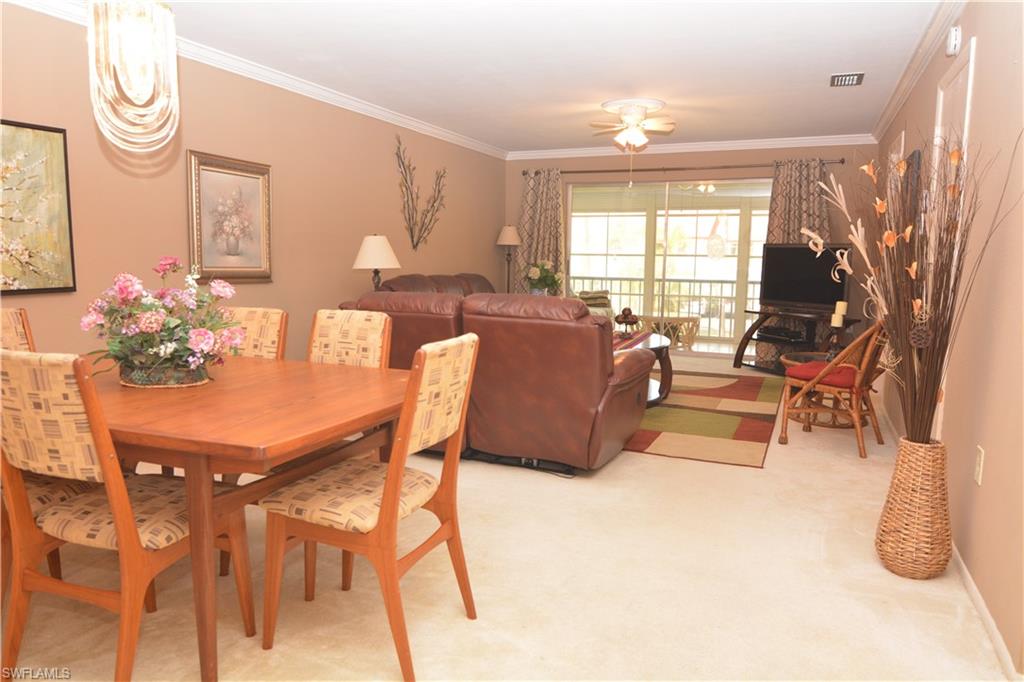 300 Valley Stream Drive, Unit A7 Naples, FL 34113 - Photo 5 of 23 a living room with furniture and a large window