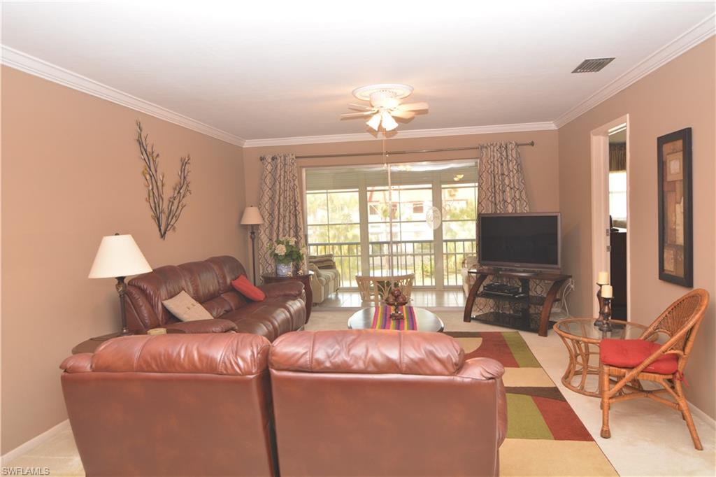 300 Valley Stream Drive, Unit A7 Naples, FL 34113 - Photo 6 of 23 a living room with furniture and a flat screen tv