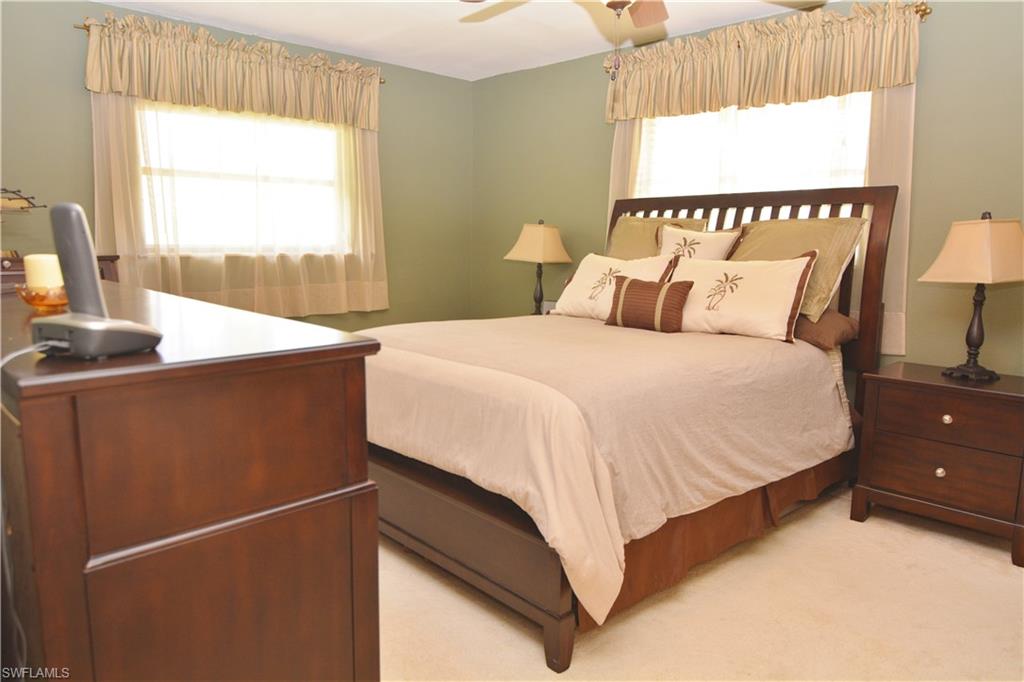 300 Valley Stream Drive, Unit A7 Naples, FL 34113 - Photo 10 of 23 a bedroom with a bed and a window